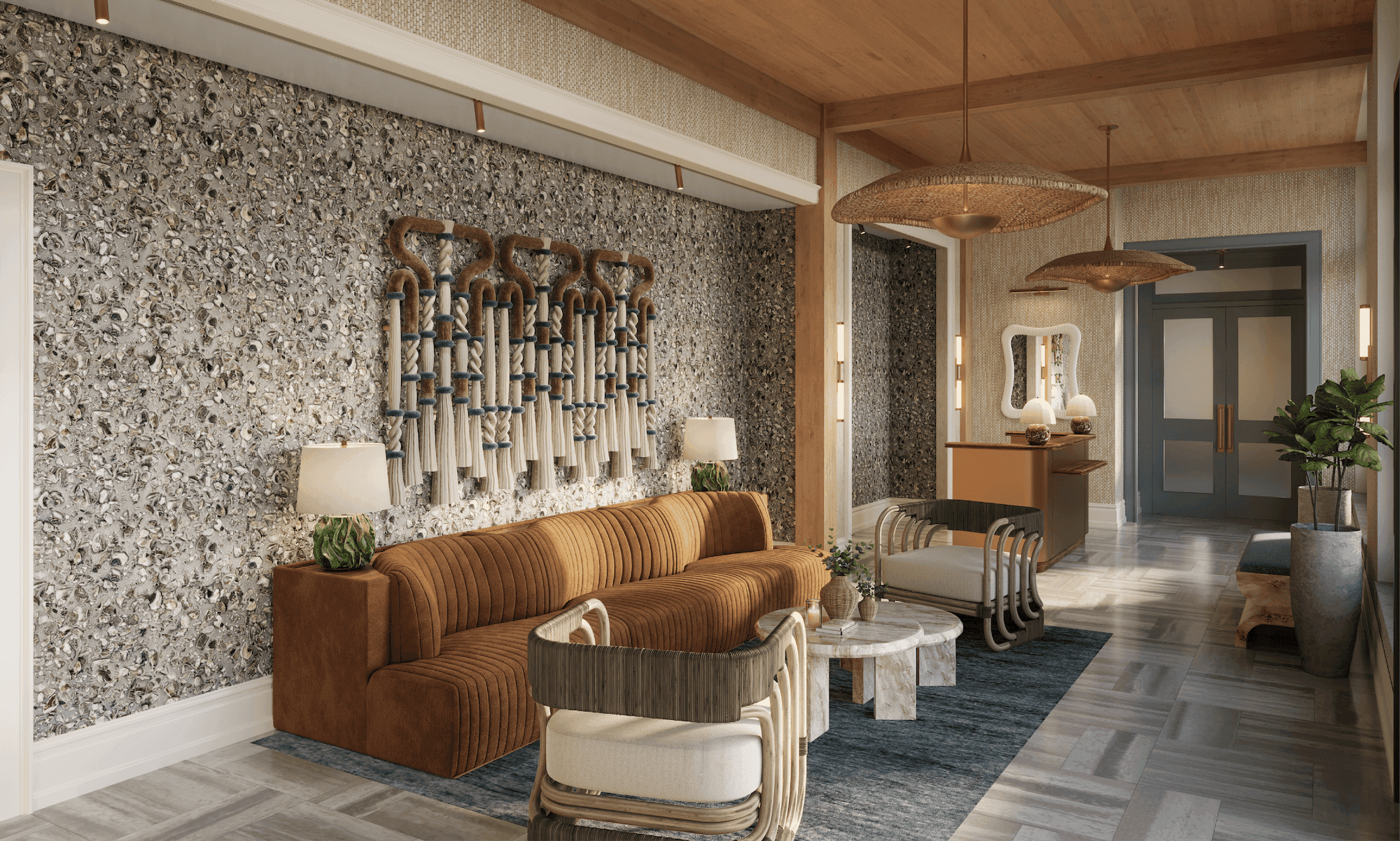 Elegant guest lobby at Sabal House Inn in Savannah's Historic District, featuring coastal-inspired decor, a textured oyster shell wall, and luxurious lounge seating.